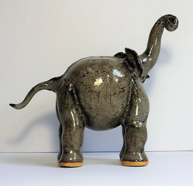 Standing elephant with tusk up