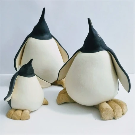 small, medium and large ceramic penguins